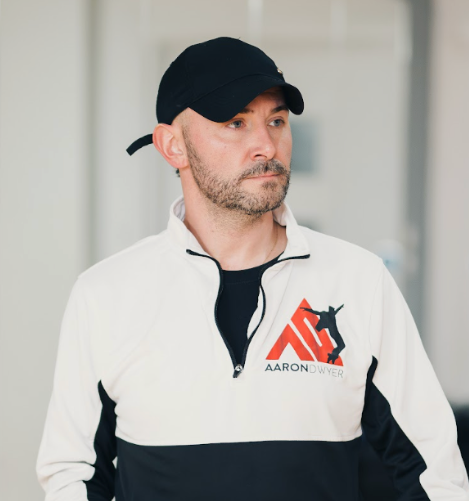 Aaron Dwyer wearing an Aaron Dwyer branded training top.